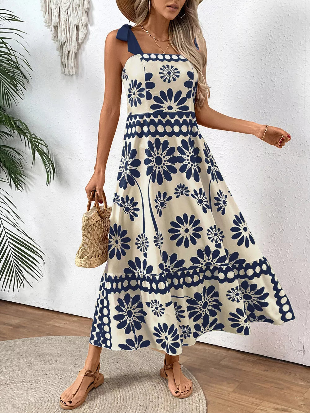 Charming floral tie-shoulder midi dress in cream with navy blue flowers, A-line cut, tiered skirt.