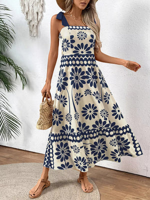 Charming floral tie-shoulder midi dress in cream with navy blue flowers, A-line cut, tiered skirt.