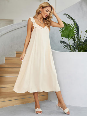 Cream midi slip dress in 100% rayon with ruffled straps and V-neck.