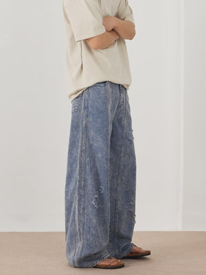 Men's blue acid wash distressed wide-leg denim jeans with a casual fit.