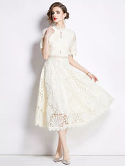Elegant white lace midi dress with delicate sleeves and a-line skirt.
