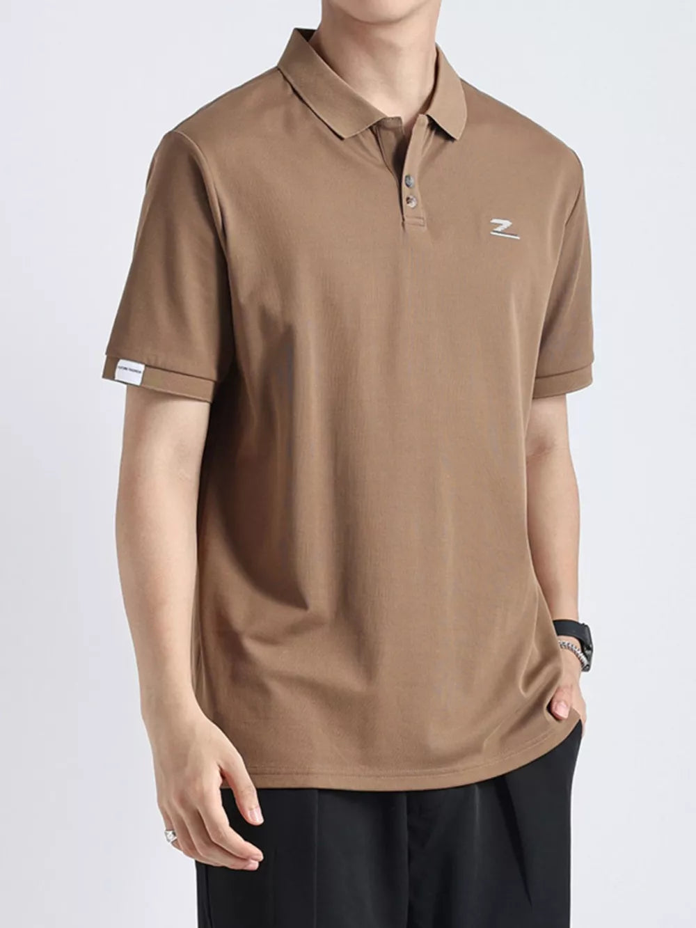 Textured casual polo in coffee color with button accents and a subtle chest logo.