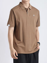 Textured casual polo in coffee color with button accents and a subtle chest logo.