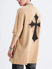 Men's tan distressed cotton graphic t-shirt with a black cross design on the back.