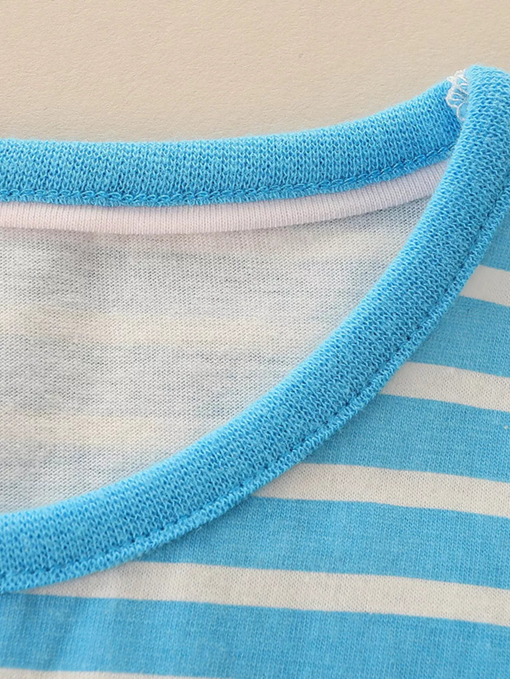 Toddler blue and white striped cotton t-shirt with a contrasting blue ribbed neckline.