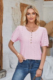 Pink perforated puff sleeve henley blouse with button detail and eyelet pattern.