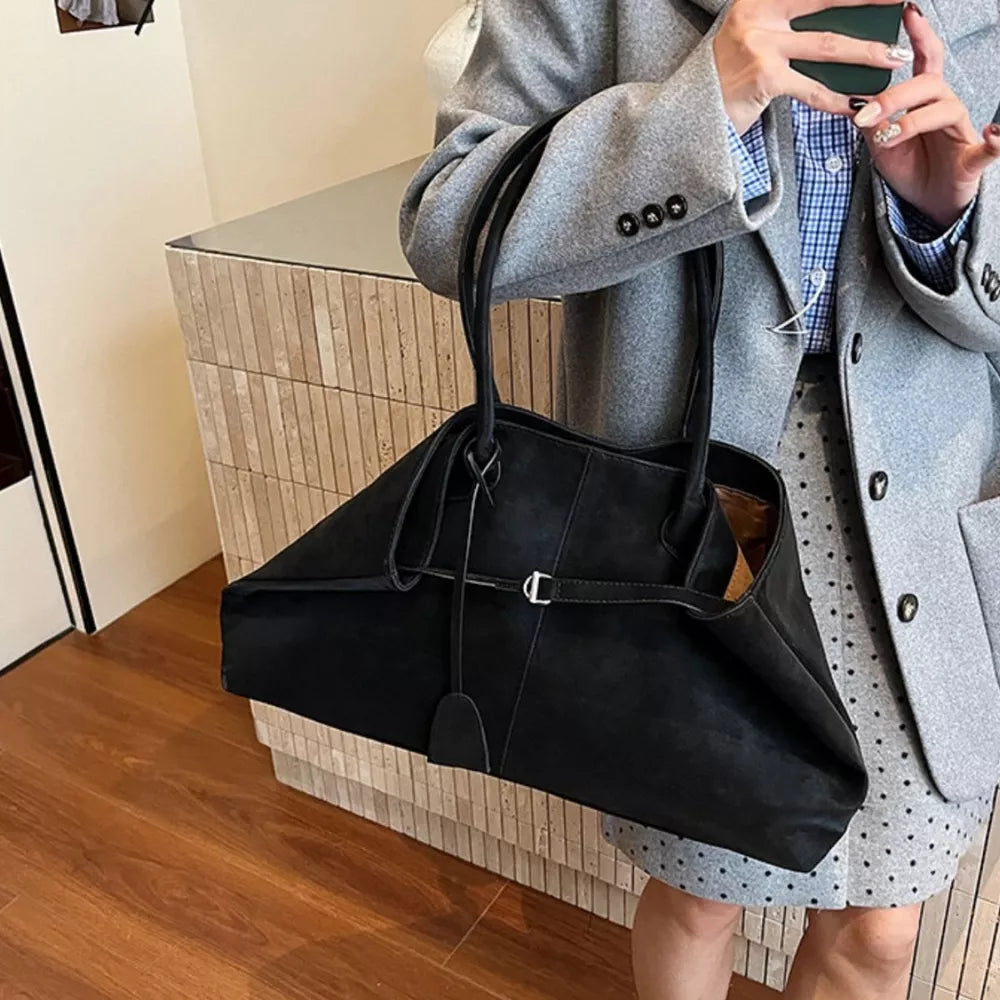 Black suede large tote handbag with decorative buckle detail and shoulder straps.