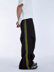 Black relaxed fit sweatpants with olive green side stripe and drawstring waist.