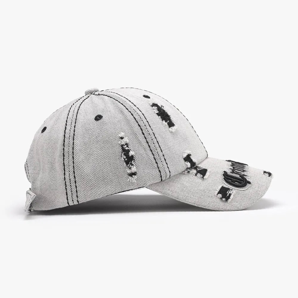 Distressed baseball cap with embroidered text detail in light grey denim.