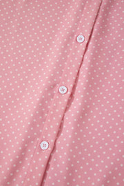 Pink polka dot print polyester button-up blouse with white buttons.