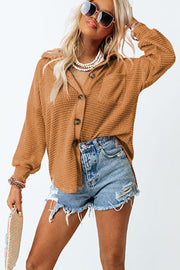 Caramel waffle knit button-down shirt jacket with collared neckline and button closure.