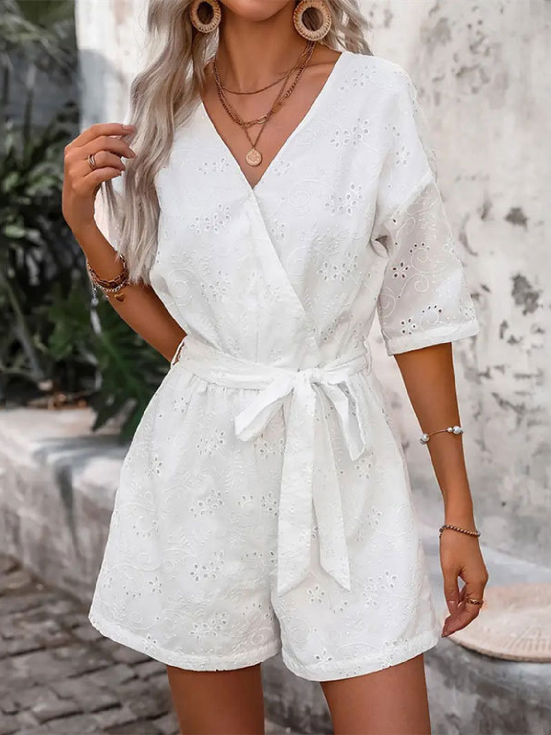 White eyelet wrap romper with tie waist and short sleeves