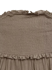 Smocked strapless romper in taupe with frill detail at neckline and hem.