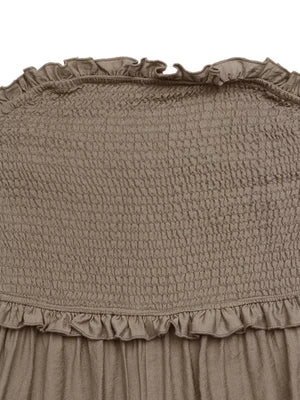 Smocked strapless romper in taupe with frill detail at neckline and hem.