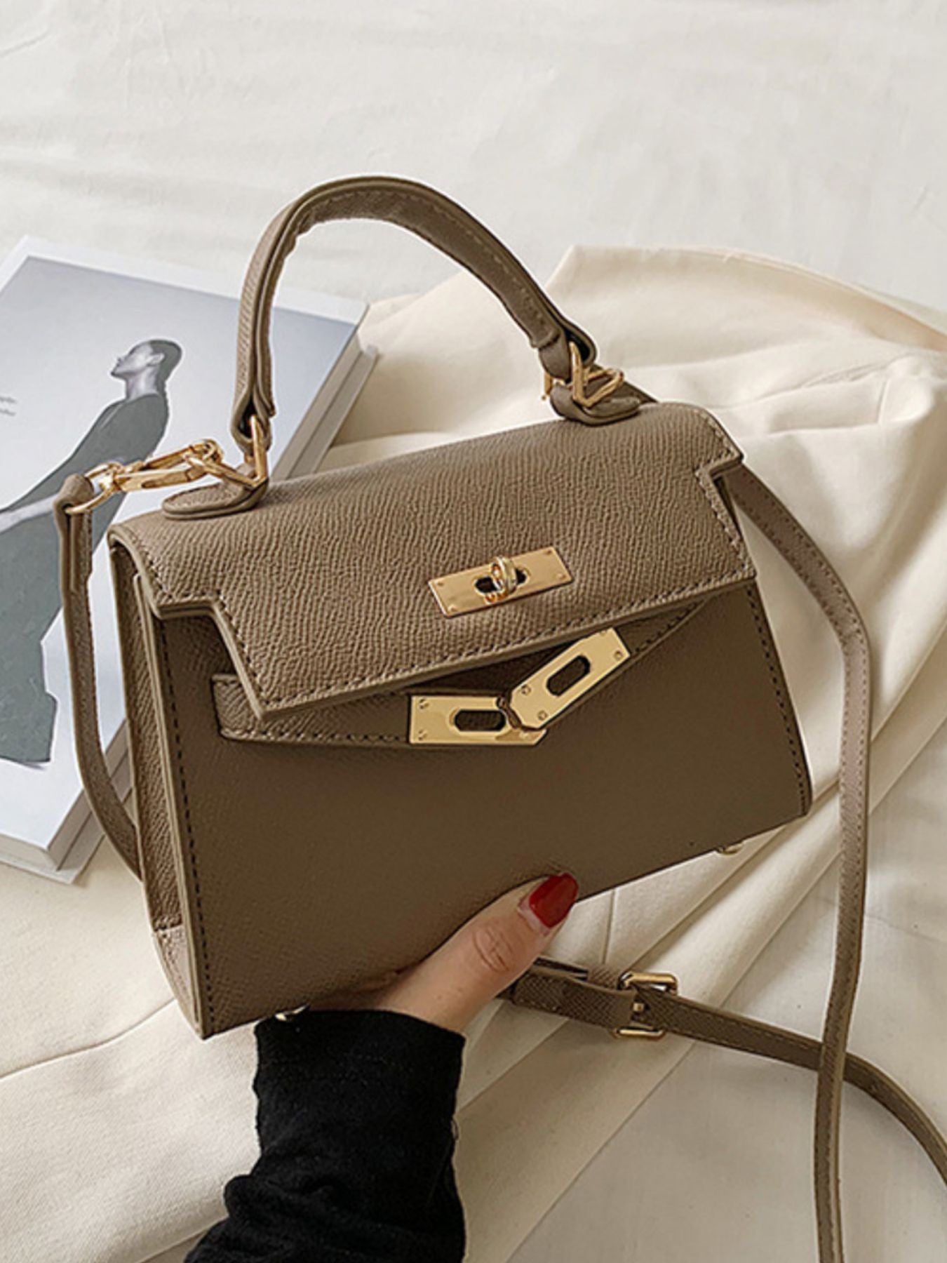 Khaki mini crossbody bag in textured faux leather with gold hardware and top handle.
