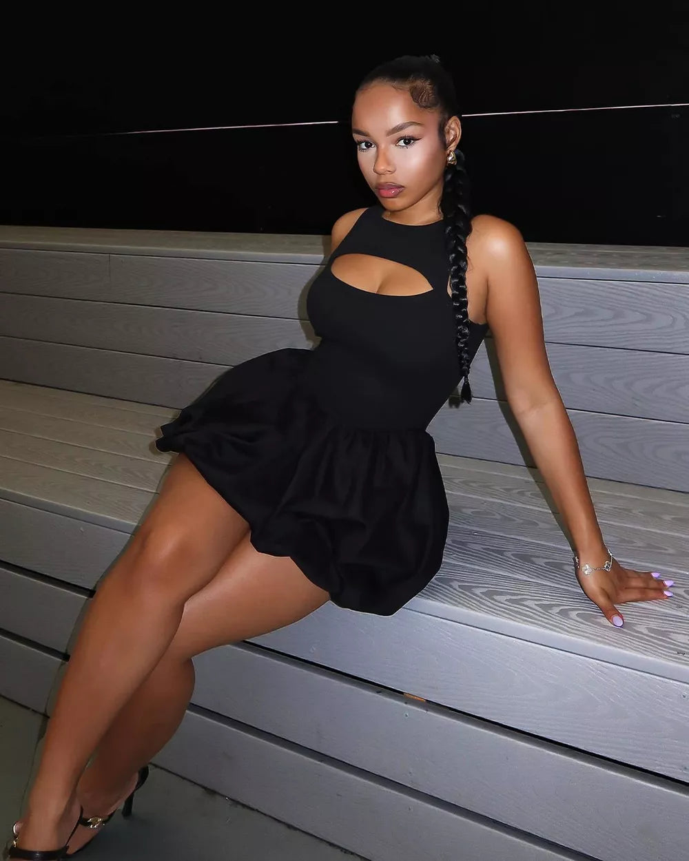 Black cutout mini dress with bubble hem and sleeveless design