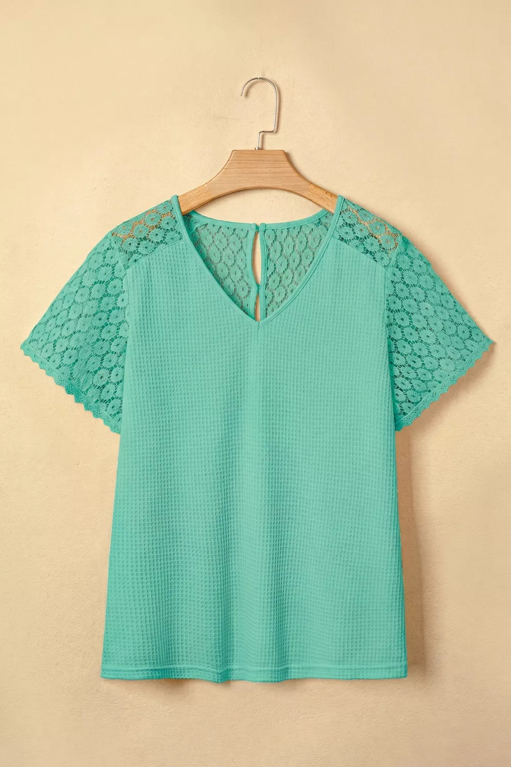 Teal waffle knit shirt with V-neck and lace short sleeves and back detail.