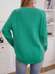 Green acrylic cable knit sweater with button shoulder detail and crew neck.