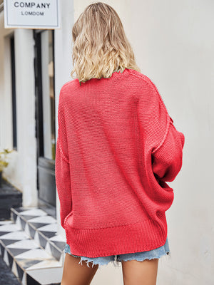 Oversized red knit V-neck sweater with slouchy fit and ribbed hem.