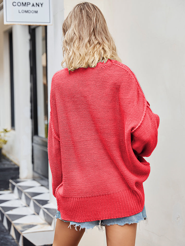 Oversized red knit V-neck sweater with slouchy fit and ribbed hem.