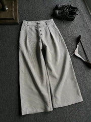 Chic high-waisted wide leg sweatpants in grey plaid with button fly and pleats.