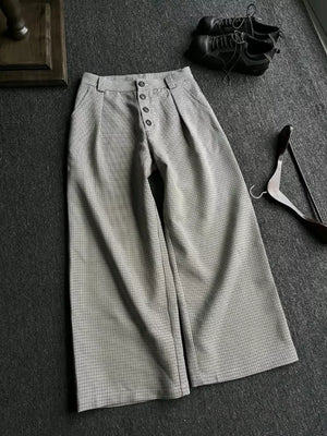 Chic high-waisted wide leg sweatpants in grey plaid with button fly and pleats.