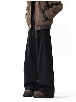 Men's black wide-leg drawstring pants with a relaxed fit.