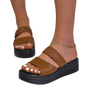 Brown two-strap platform sandals with braided detail and chunky sole.