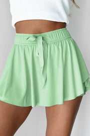 Flared skort in Gum Leaf green with elastic waist and tie detail.