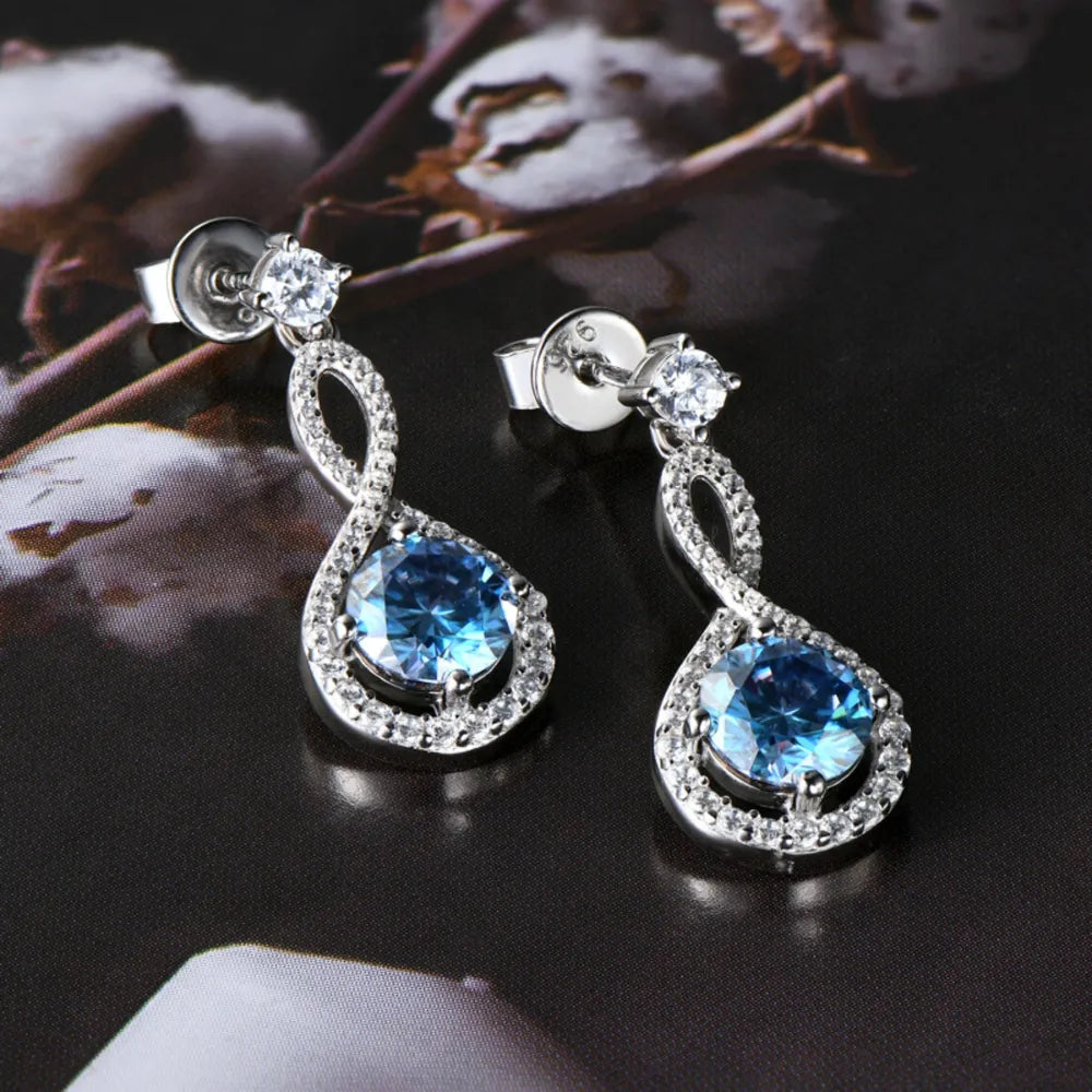 Infinity drop earrings with royal blue aquamarine and white crystals