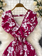 Rose Red floral print romper with ruffled sleeves and smocked waist.