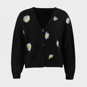 Black V-neck cardigan with allover daisy embroidery and button front.