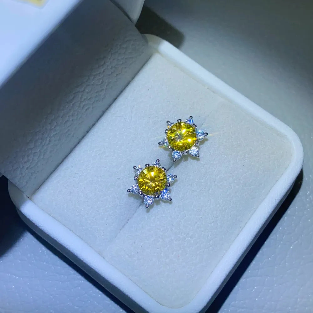 Golden sunburst moissanite stud earrings in silver with sparkling accents.