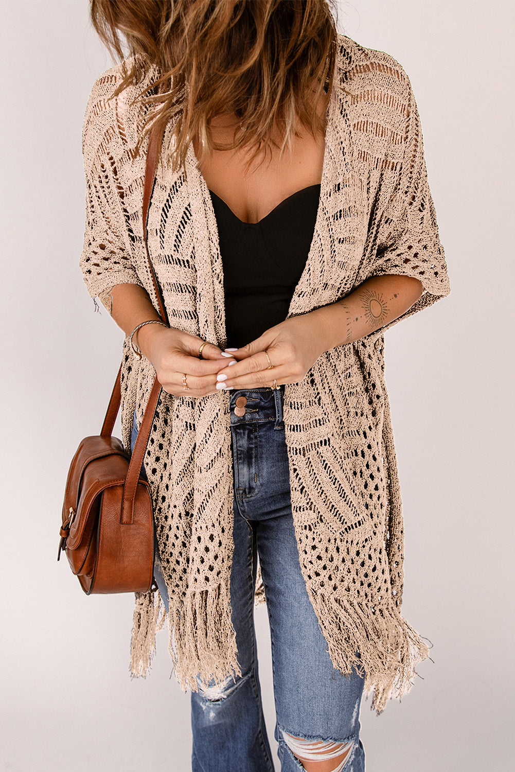 Tan open knit chevron fringe cardigan with short sleeves.