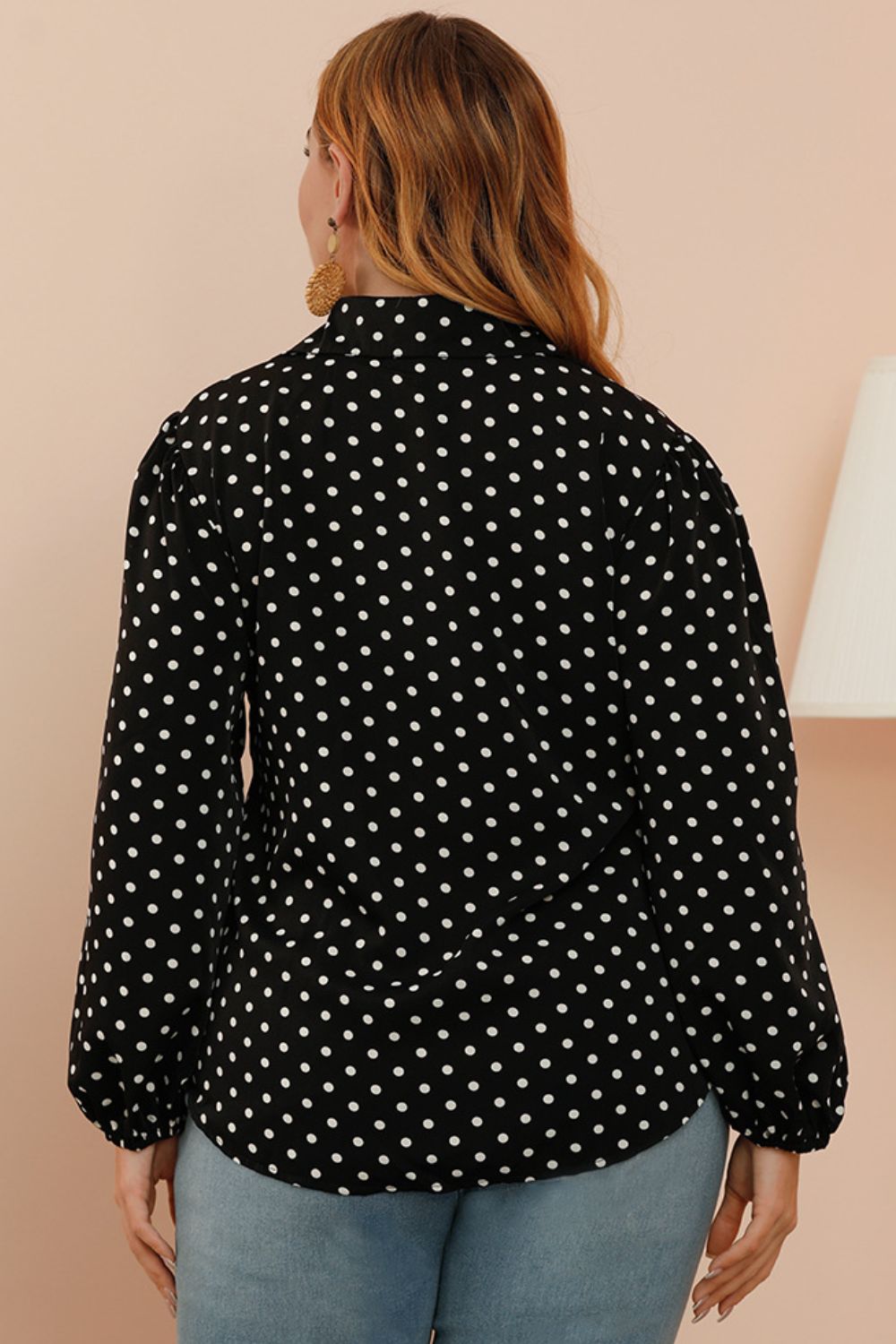 Black polka dot blouse with shirred balloon sleeves.