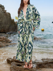 Green boho print maxi beach cover-up with tie waist and wide sleeves.