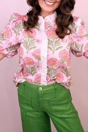 Pink floral puff sleeve maternity blouse with ruffled placket and striped collar.