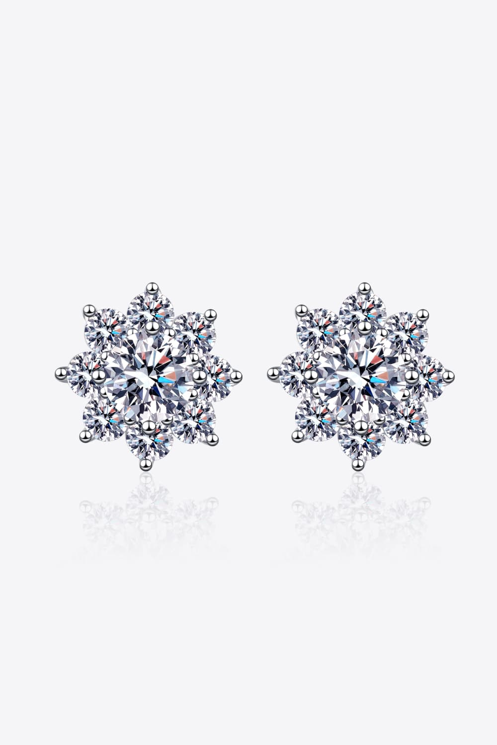Silver blossom moissanite earrings with sparkling cubic zirconia details.