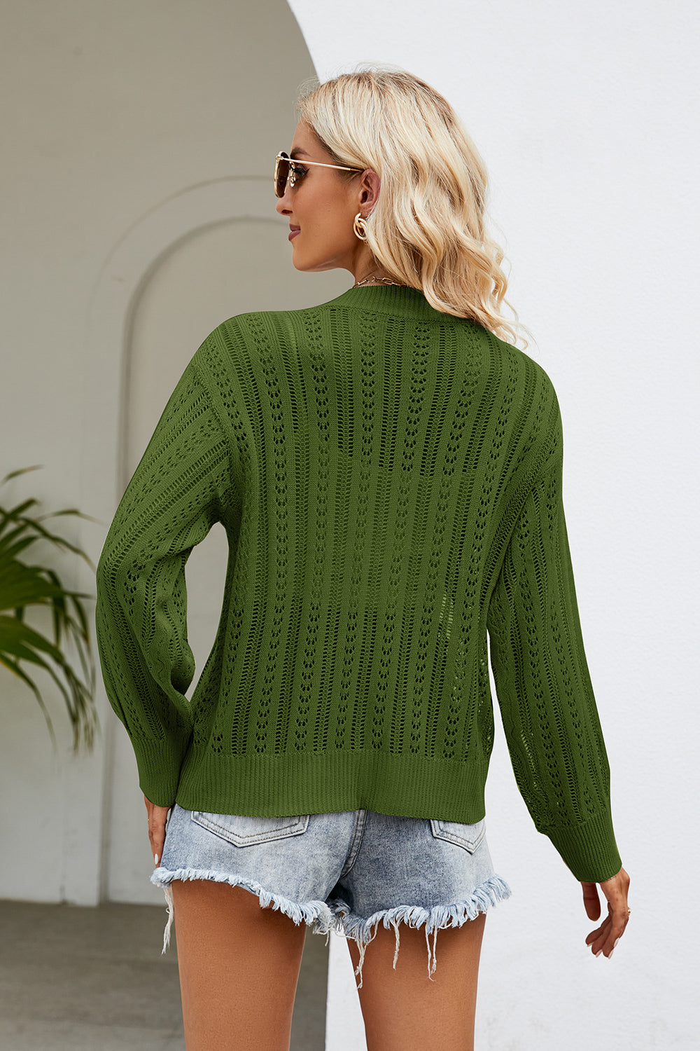 Green openwork knit button-down cardigan with long sleeves and a relaxed fit.