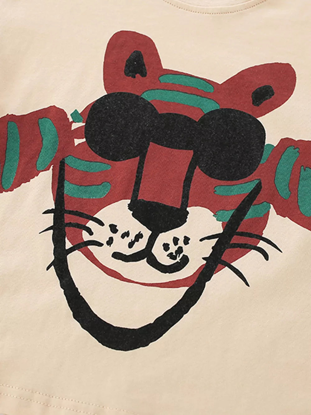 Cream cotton baby tee with a whimsical red tiger graphic and black sunglasses.