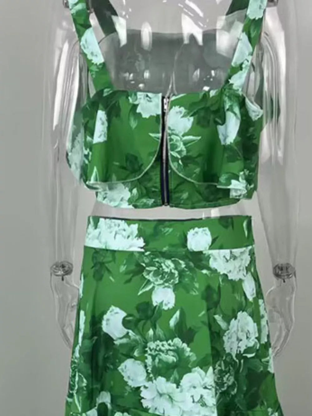 Green floral two-piece set with ruffled crop top and high-waisted skirt.