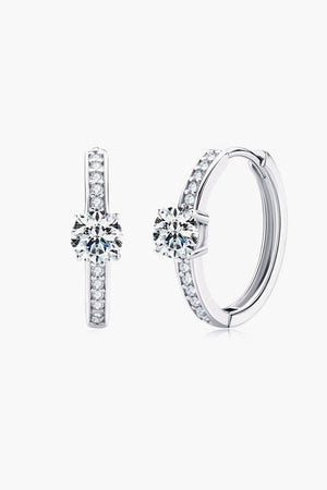 Silver pavé halo moissanite hoop earrings with a central solitaire stone.
