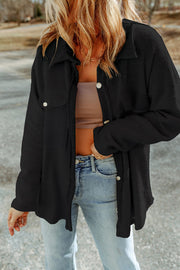 Black textured shacket with raw-edge detailing and button closure
