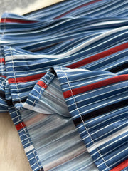 Patchwork denim midi skirt with red, white, and blue stripes and asymmetrical detail.