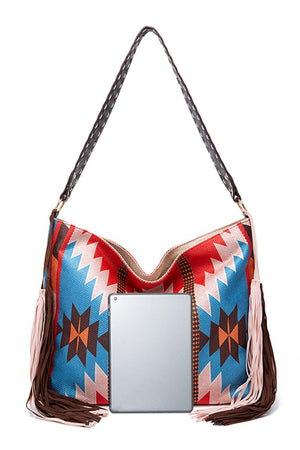 Southwestern fringe hobo bag in multicolor canvas with a braided strap and leather fringe detail.