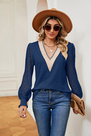 Navy blue blouse with lace sleeves and V-neck with cream trim