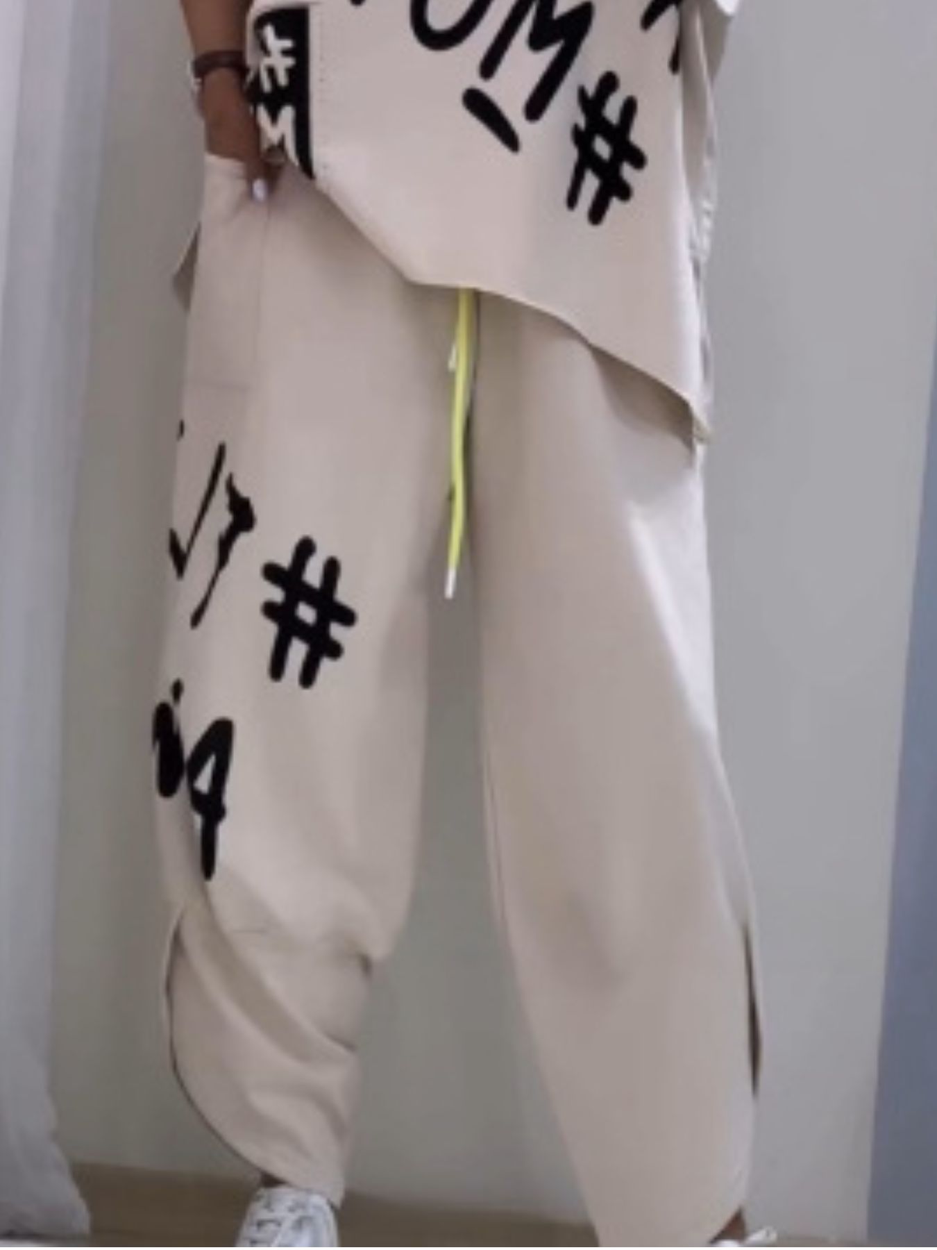 Khaki graphic tee and drawstring pants set with bold black lettering and hash symbols.