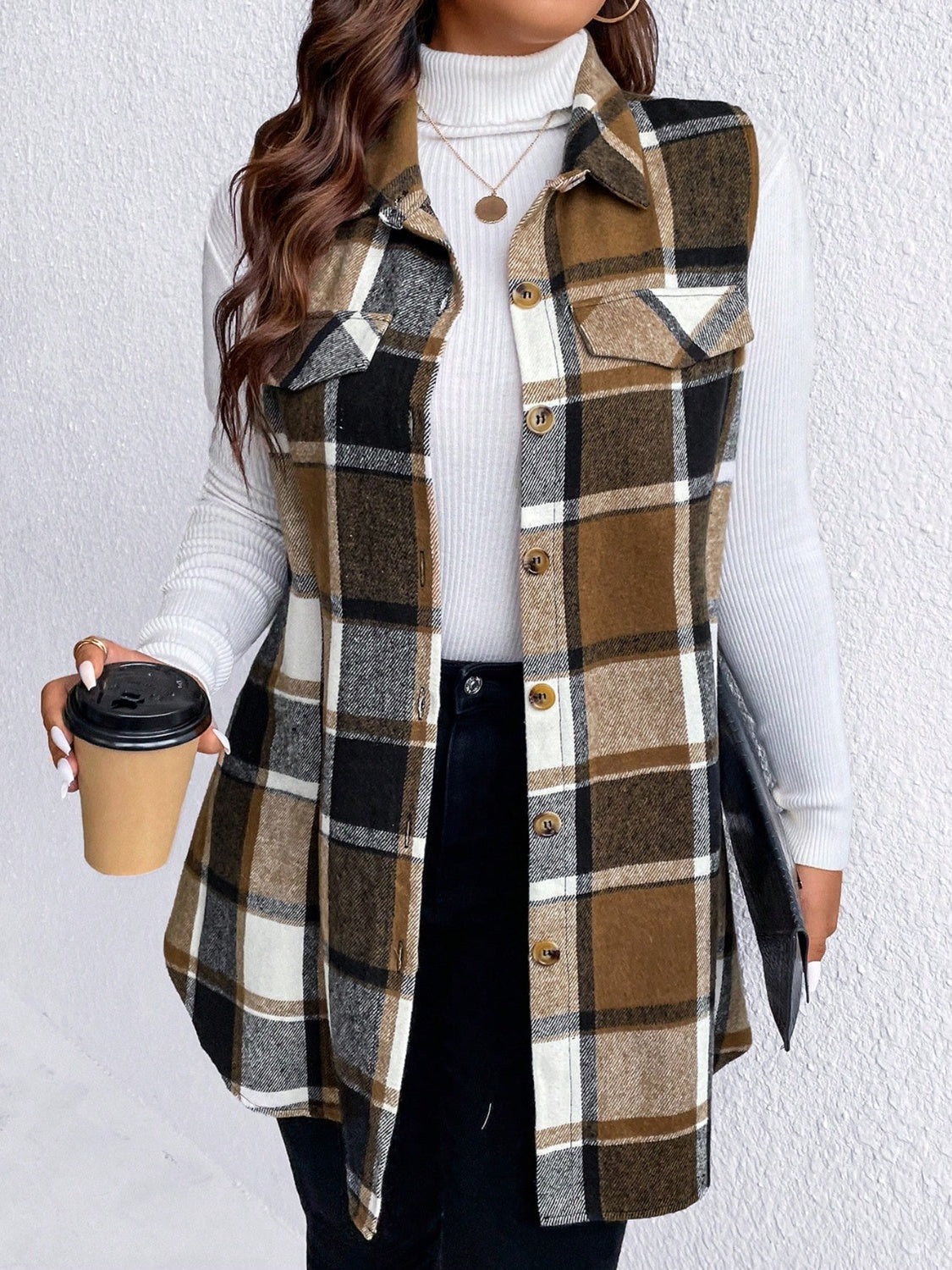 Oversized plaid shirt vest in brown, black, and camel with button front and chest pockets.