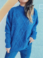 Blue sparkle knit sweater with diamond pattern and mock neck.