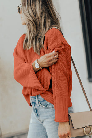 Textured knit sweater in ochre with wide bell sleeves and side slits.